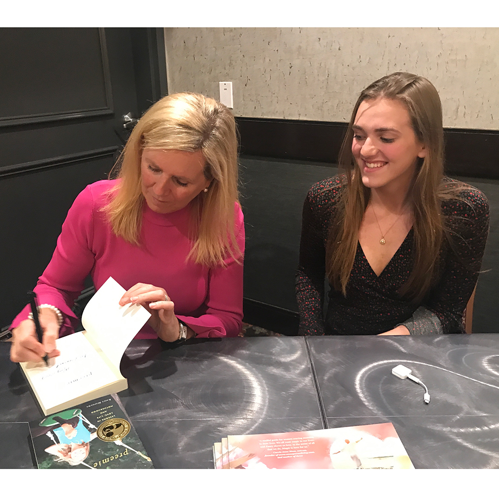at a speaking event with my daughter signing books
