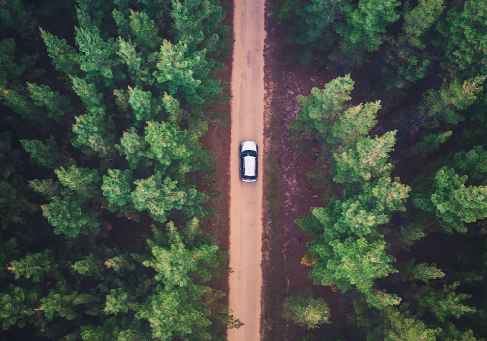 a car driving down a road representing moving forward toward positive changes in life