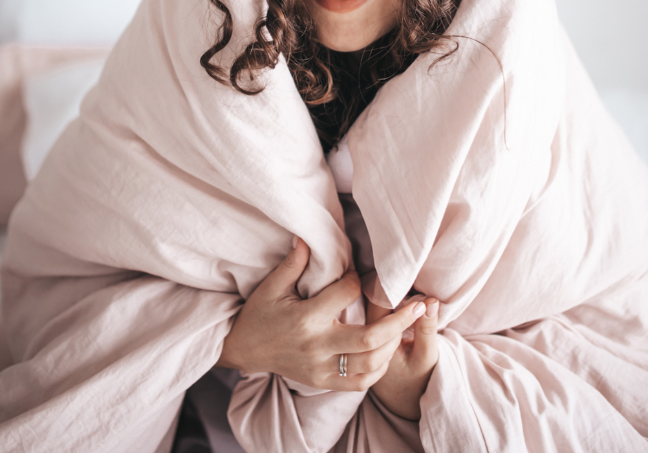 a woman wrapped in a blanket giving herself permission to care for herself