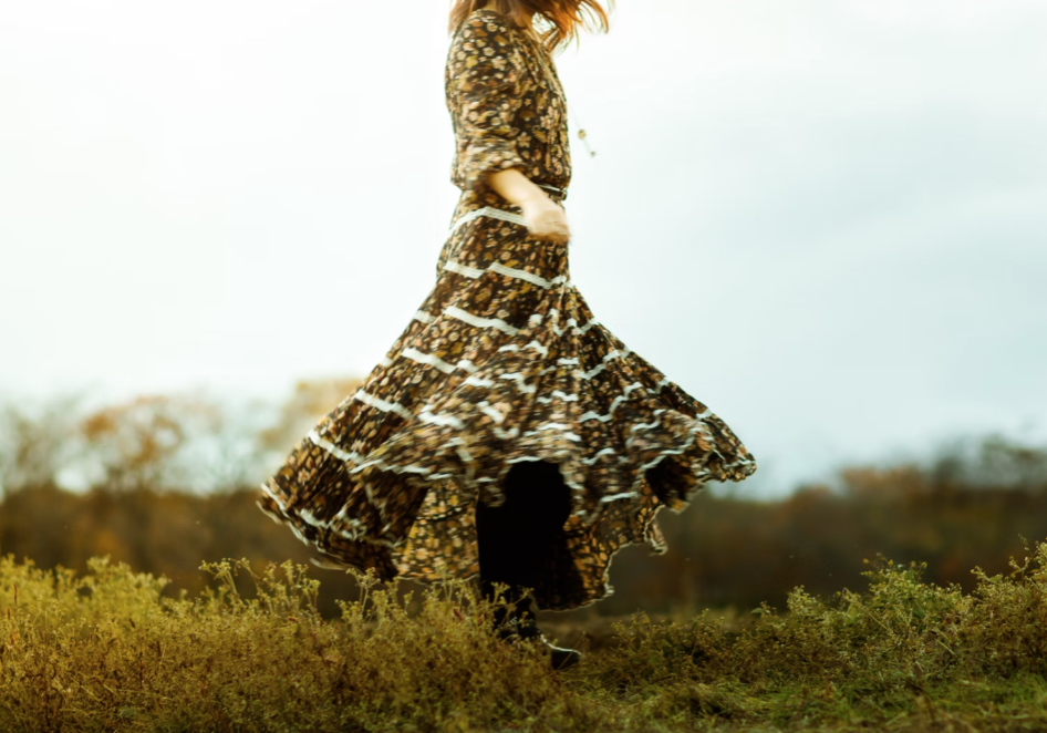 a women in a dress who decided to stop waiting and live fully